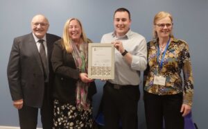 Pelton holding their Gold Award with CDALC 